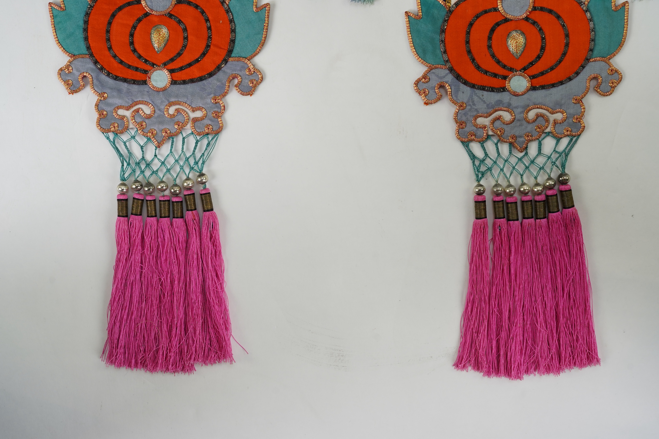 A pair of Chinese embroidered silk hanging pendants, early 20th century